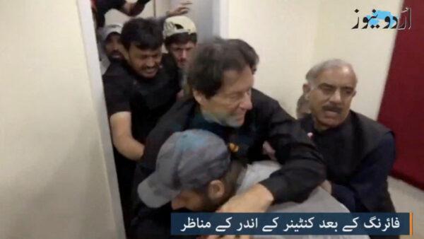 Former Pakistani Prime Minister Imran Khan is helped after he was shot in the leg in Wazirabad, Pakistan, on Nov. 3, 2022, in this still image obtained from a video. (Urdu Media via Reuters)