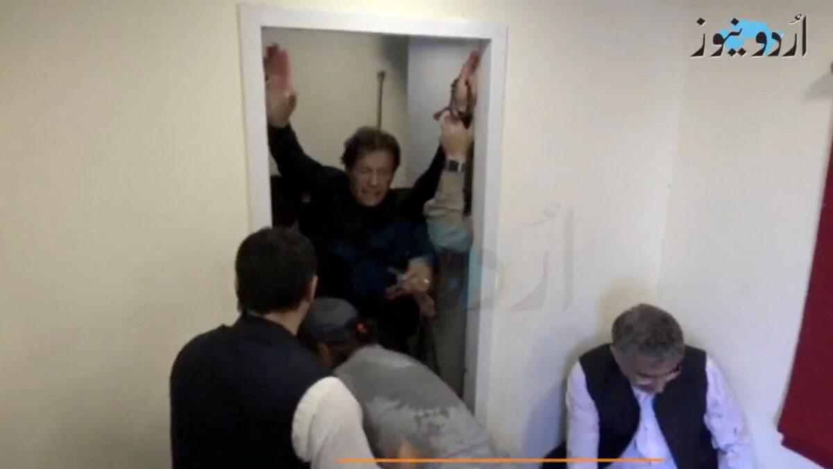 Former Pakistani Prime Minister Imran Khan is helped after he was shot in the shin in Wazirabad, Pakistan, on Nov. 3, 2022, in this still image obtained from video footage. (Urdu Media via Reuters)