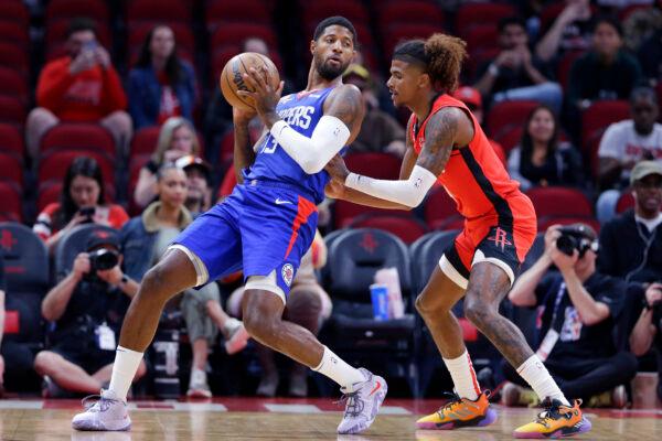 Los Angeles Clippers guard Paul George (13) leans back into Houston Rockets guard Jalen Green during the first half of an NBA basketball game in Houston, Nov. 2, 2022. (Michael Wyke/AP Photo)