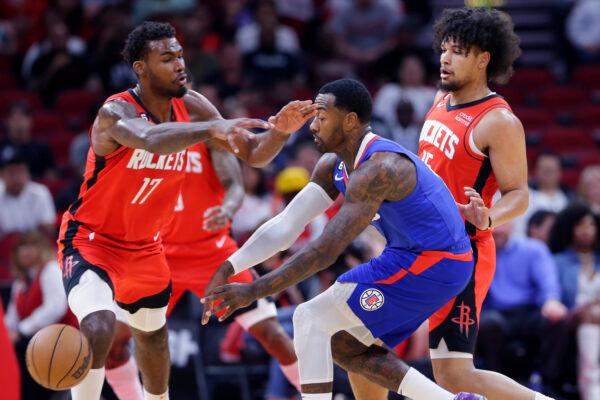 Los Angeles Clippers guard John Wall, middle, passes the ball away from Houston Rockets forward Tari Eason (17) and guard Daishen Nix, right, during the first half of an NBA basketball game in Houston, on Nov. 2, 2022. (Michael Wyke/AP Photo)