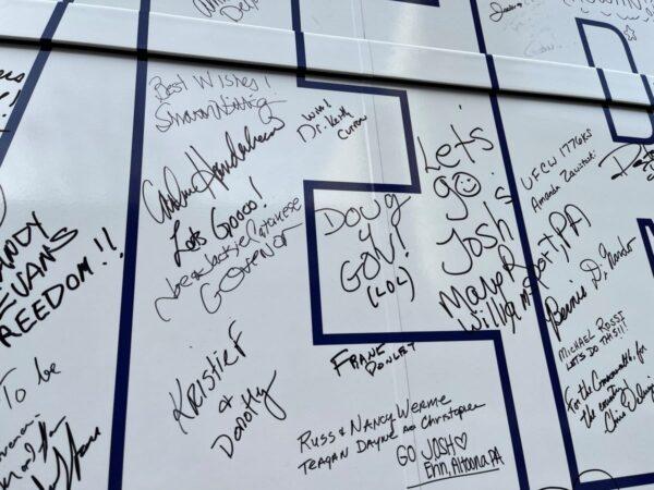 At Democrat Josh Shapiro’s Pennsylvania bus stops, supporters are invited to write well wishes on his campaign bus. Someone added support for his opponent Doug Mastriano. (Beth Brelje/The Epoch Times)