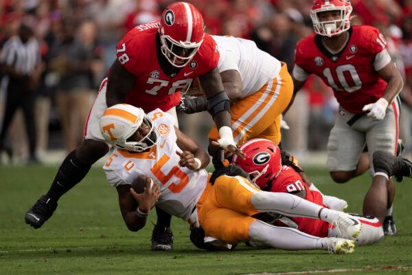 Tennessee quarterback Hendon Hooker (5) is sacked by Georgia defensive linemen Tramel Walthour (90) and Nazir Stackhouse (78) during the first half of an NCAA college football game in Athens, Ga., on Nov. 5, 2022. (John Bazemore/AP Photo)