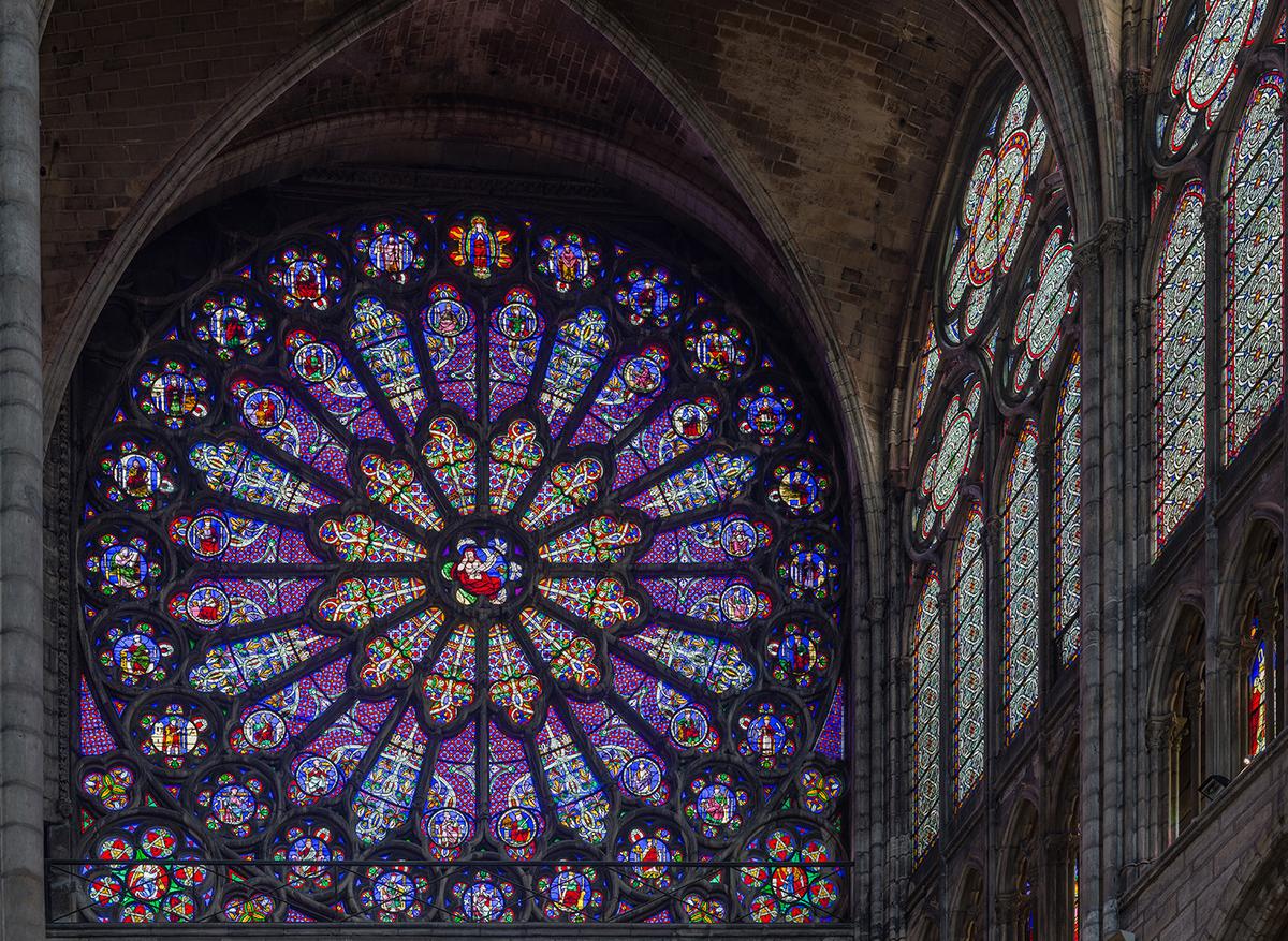 Light and color were central to Suger’s conception. The use of rib vaulting and pointed arches opened up the interior space, allowing for a brighter and more colorful atmosphere. Pictured here is the stained glass rose window of the north transept. (<a href="https://commons.wikimedia.org/wiki/File:Basilica_of_Saint_Denis_North_Transept_Rose_Window,_Paris,_France_-_Diliff.jpg">Diliff/</a><a href="https://creativecommons.org/licenses/by-sa/3.0">CC BY-SA 3.0</a>, via Wikimedia Commons)