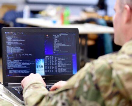 U.S. Air Force Capt. Shannon Bender, 272nd Cyber Operations Squadron, 110th Wing, Michigan Air National Guard, reviews computer information during a cyber-warfare training event, Camp Grayling Joint Maneuver Training Center, Mich., on March 8, 2022. (U.S. Air National Guard/Master Sgt. David Eichaker)