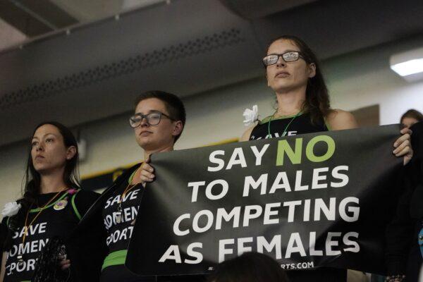 Women protest as Pennsylvania transgender athlete Lia Thomas competes in the women's 200 freestyle final at the NCAA swimming and diving championships at Georgia Tech in Atlanta on March 18, 2022. (John Bazemore/AP Photo)