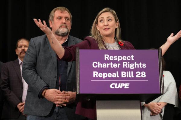 CUPE-OSBCU president Laura Walton (R) answers a question as CUPE president Mark Hancock looks on during a press conference in Toronto on Nov. 7, 2022. (The Canadian Press/Nathan Denette)