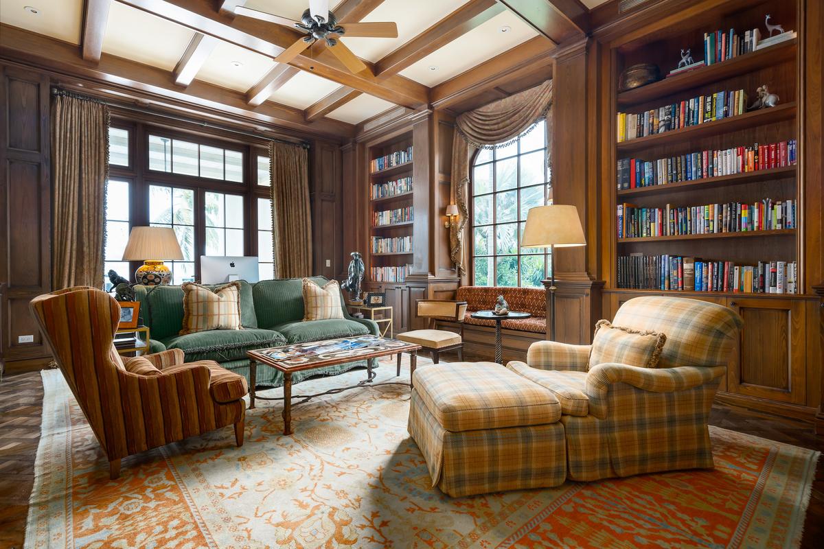 The home’s wood-paneled library is warm and inviting, an ideal place to escape into the pages of a favorite book. (Courtesy of Damianos Sotheby’s International Realty)