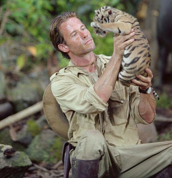 Hunter-explorer Aiden McRory (Guy Pearce) saves a tiger cub, in "Two Brothers." (MovieStillsDB)