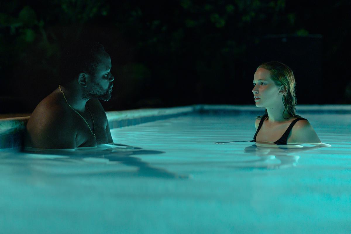 Mechanic James (Brian Tyree Henry) and Army vet Lynsey (Jennifer Lawrence) have a swim in her vacationing customer's pool, in "Causeway." (A24)