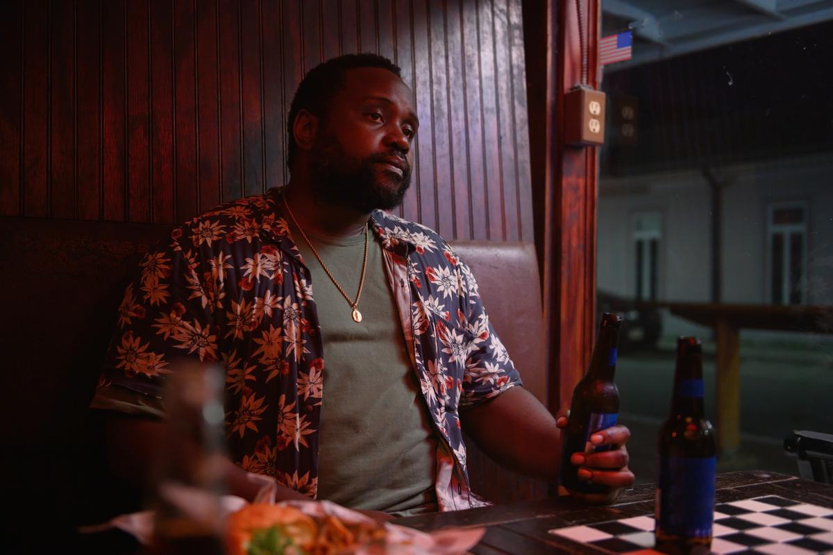 James (Brian Tyree Henry) about to intervene for his friend Lynsey, who's getting obnoxiously hit on in a bar, in "Causeway." (A24)