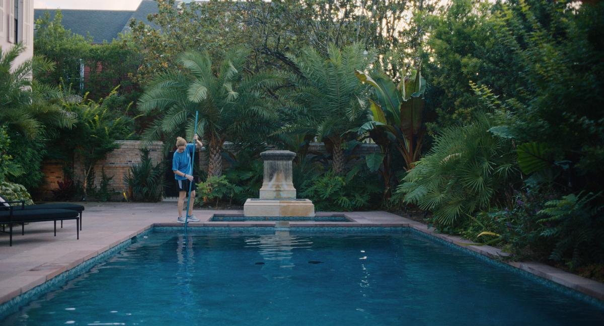Army vet Lynsey (Jennifer Lawrence) cleaning a pool, in "Causeway." (A24)