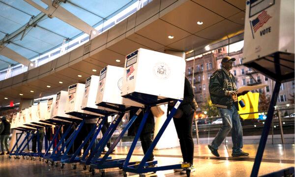 The first voters of the day begin filling out their ballots at a polling site in the Brooklyn Museum as the doors open for the midterm elections in New York on Nov. 8, 2022. (John Minchillo/AP Photo)