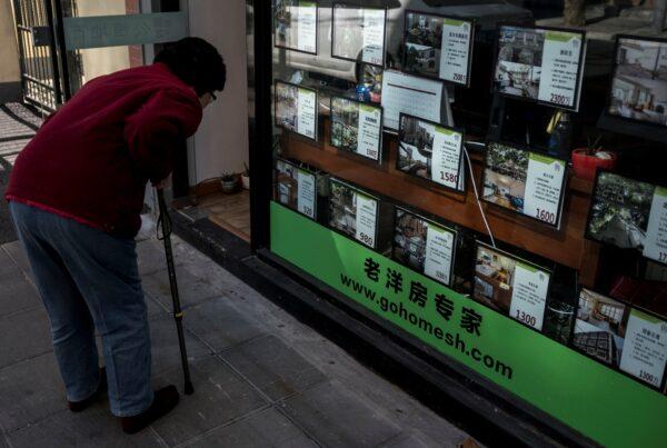 An elderly woman looks at the price tags of houses at a local real estate office in downtown Shanghai on Feb. 12, 2018. (Johannes Eisele/AFP via Getty Images)