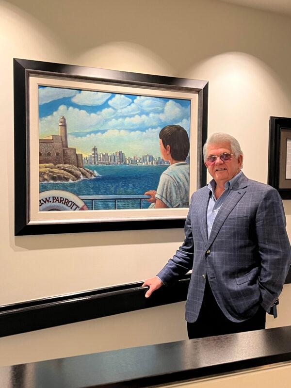  Maximo Alvarez stands before a painting done by a Cuban artist depicting him fleeing Havana on the last cargo ship leaving Cuba on July 4, 1961 (Courtesy of Maximo Alvarez).