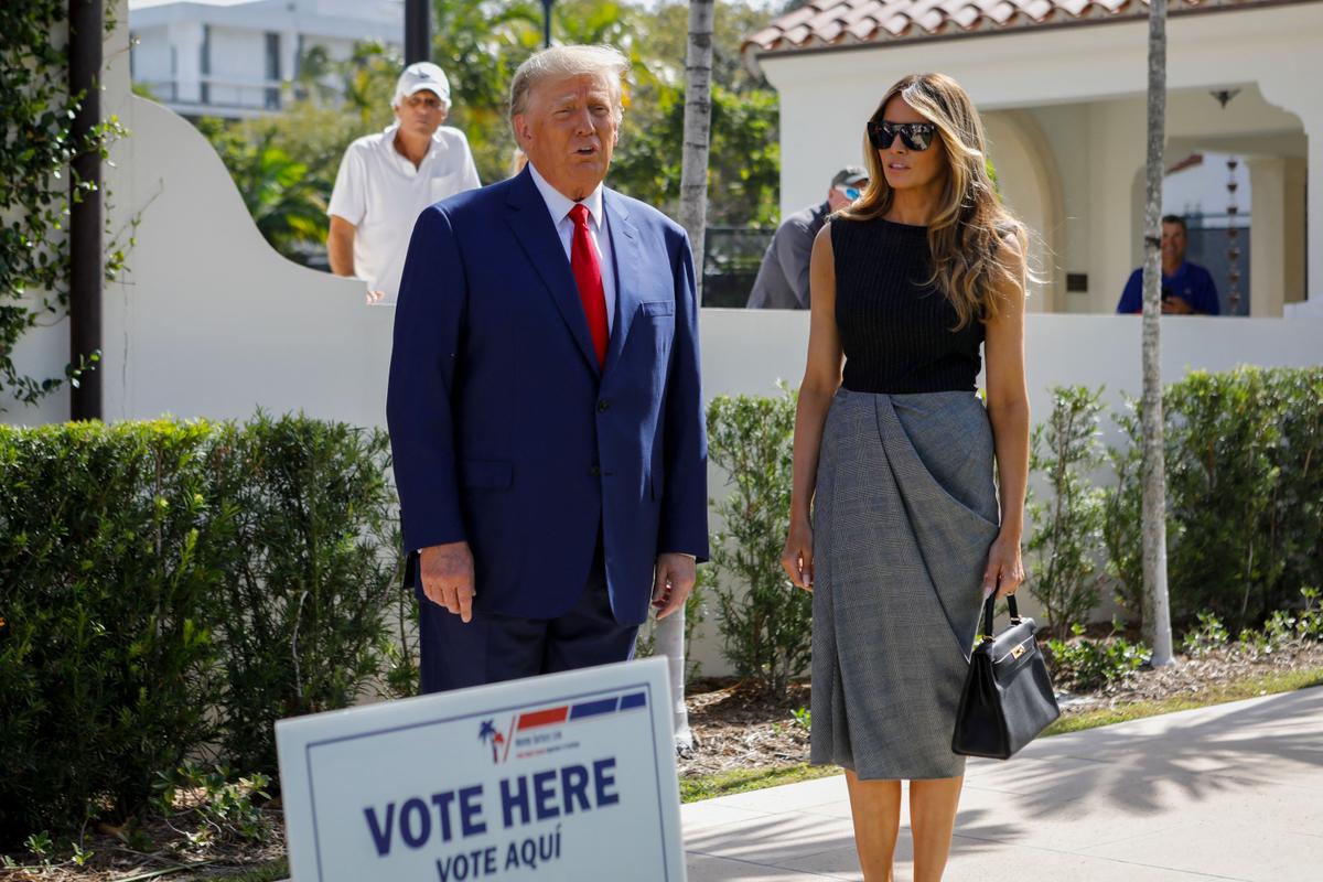 Former President Donald Trump and former First Lady Melania Trump speak to the media while departing a polling station after voting in the midterm elections at Morton and Barbara Mandel Recreation Center in Palm Beach, Fla., on Nov. 8, 2022. (Eva Marie Uzcategui/AFP via Getty Images)