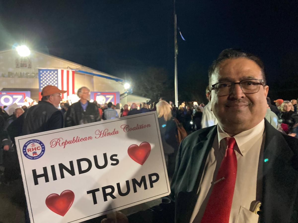 Yagnesh Choksi, president of the South Asian Republican Coalition of Pennsylvania, shows his support for Republican U.S. Senate candidate, Dr. Mehmet Oz, at a rally in Pennsburg, Pa., on Nov. 7, 2022. (Janice Hisle/The Epoch Times)