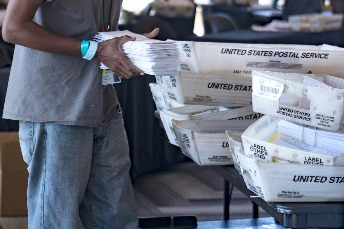 An election worker processes absentee ballots in Atlanta, Ga., on Nov. 2, 2020. (Megan Varner/Getty Images)