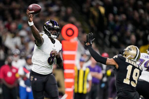 Baltimore Ravens quarterback Lamar Jackson (8) throws under pressure from New Orleans Saints safety Chris Harris Jr., (19) in the first half of an NFL football game in New Orleans, on Nov. 7, 2022. (Gerald Herbert/AP Photo)