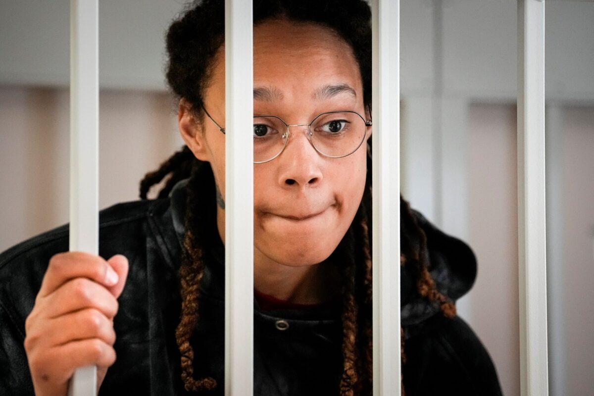 WNBA star and two-time Olympic gold medalist Brittney Griner speaks to her lawyers standing in a cage at a courtroom prior to a hearing, in Khimki just outside Moscow on July 26, 2022. (Alexander Zemlianichenko, Pool/AP Photo)