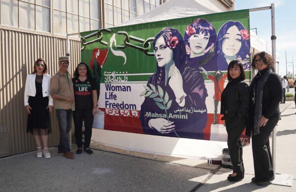 Sudi Farokhnia (3rd L) also organized the "Woman, Life, Freedom" art exhibit earlier this month at the Holiday Faire at Great Park in Irvine, Calif., on Nov. 5, 2022. (Rudy Blalock/The Epoch Times)