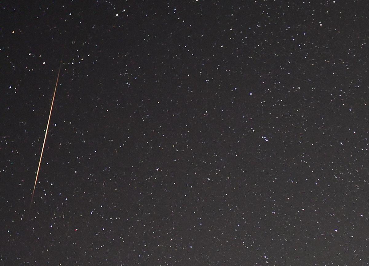 A close-up view shows a meteor streaking across the sky as the Earth passes through the debris trails of a broken comet. (Illustration - Ethan Miller/Getty Images)