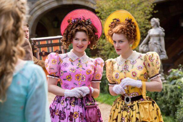 Cinderella's stepsisters (Holliday Grainger, C, and Sophie McShera, R) beg Cinderella's forgiveness, and she welcomes them into her new home, in "Cinderella." (MovieStillsDB)