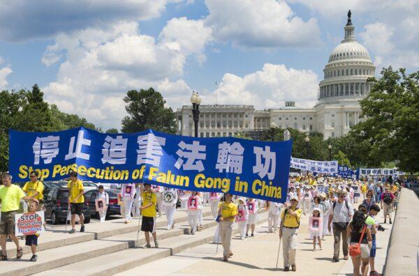 Falun Gong demonstrators march on Capitol Hill in Washington on July 17, 2014, as part of the events sponsored by the Falun Dafa Association of Washington, DC, to end "Chinese persecution of Falun Gong practitioners." (Jim Watson/AFP via Getty Images)
