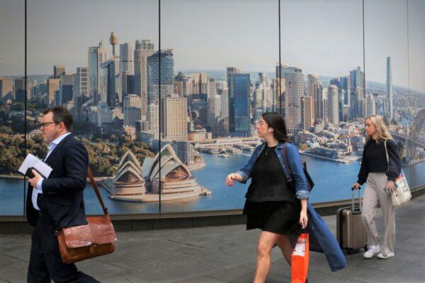 Pedestrians move past a billboard along George Street in Sydney, Australia on Oct. 18, 2022. (Lisa Maree Williams/Getty Images)
