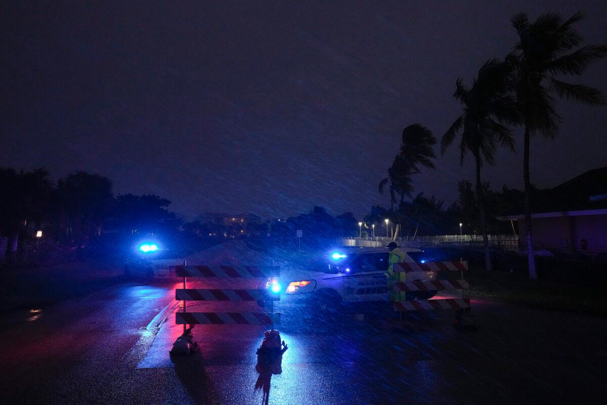 Police block off MacArthur Boulevard on Hutchinson Island as conditions deteriorate with the approach of Hurricane Nicole, in Jensen Beach, Fla., on Nov. 9, 2022. (Rebecca Blackwell/AP Photo)