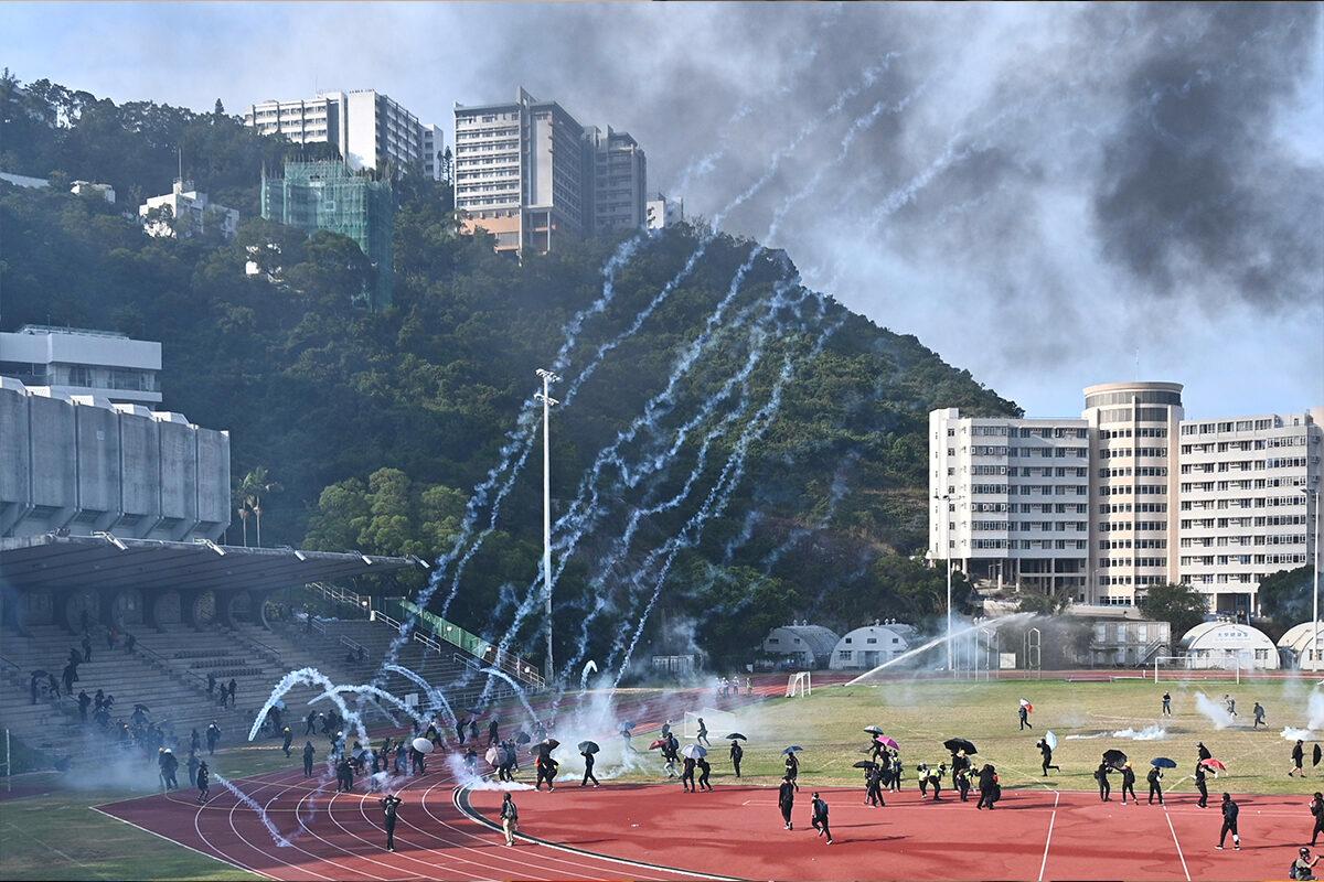Protesters react after police fired tear gas at the Chinese University of Hong Kong (CUHK) on Nov. 12, 2019. (Philip FONG/AFP)