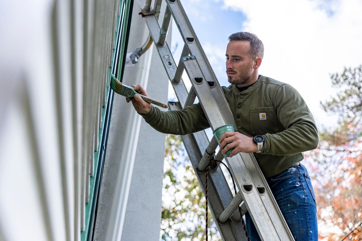Sean O’Donnell, the resident caretaker and restorer of the Knight Park House in Collingswood, New Jersey, is painting the original cedar trim on the 134-year-old structure. (Tyger Williams/The Philadelphia Inquirer/TNS)