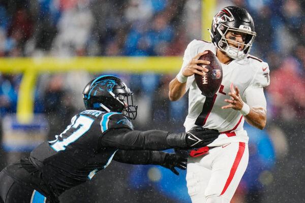 Atlanta Falcons quarterback Marcus Mariota passes under pressure from Carolina Panthers defensive end Yetur Gross-Matos during the second half of an NFL football game in Charlotte, N.C., on Nov. 10, 2022. (Rusty Jones/AP Photo)