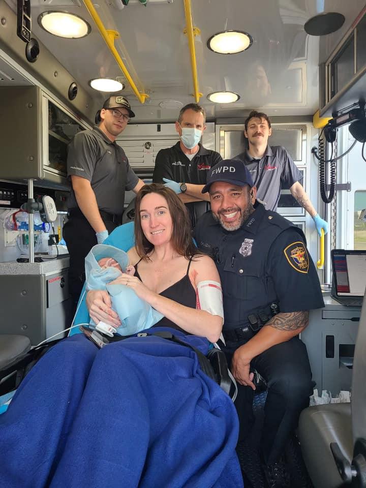 Leah Reeves with her newborn baby alongside Police Officer Rafael Salazar. (Courtesy of Fort Worth Police Department)