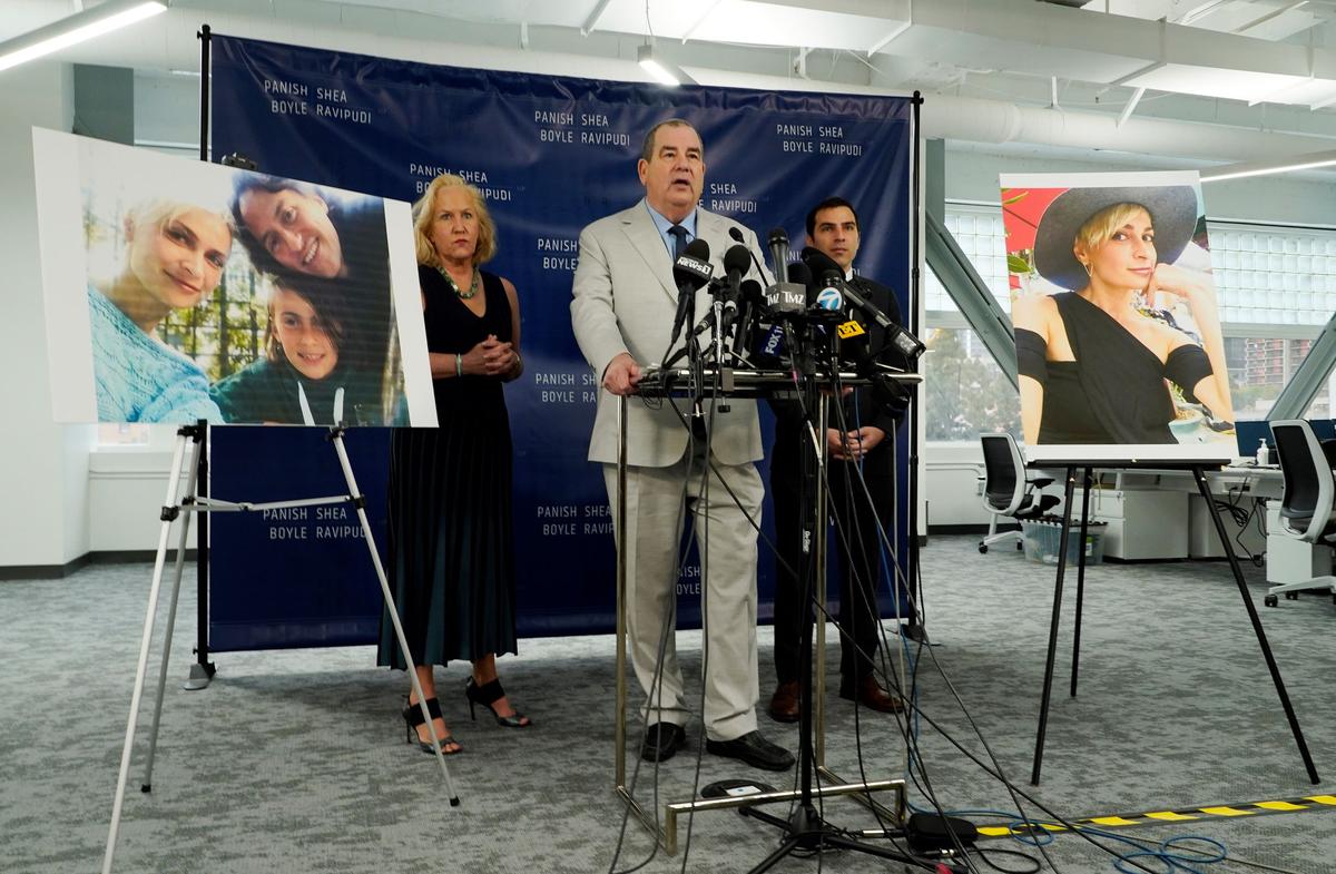 Randi McGinn, from left, Brian Panish and Jesse Creed, attorneys for the family of cinematographer Halyna Hutchins, take part in a news conference alongside portraits of Hutchins and her family in Los Angeles, on Feb. 15, 2022. (Chris Pizzello/AP Photo)