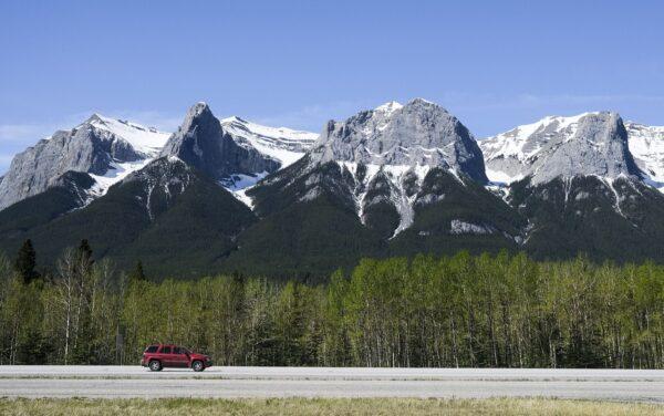 A vehicle on the Trans-Canada Highway passing through Canmore, Alta., on May 30, 2021. (The Canadian Press/Jeff McIntosh)