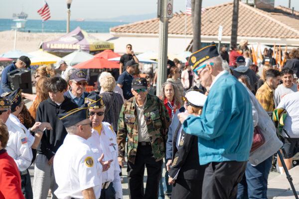 A crowd gathers for the Veterans Day ceremony at Pier Plaza in Huntington Beach, Calif., on Nov. 11, 2022. (Julianne Foster/The Epoch Times)