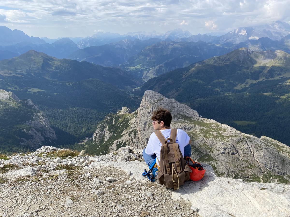 A hiker in Italy’s Dolomite Mountains takes a break to enjoy the scenery. (Courtesy of Margot Black)