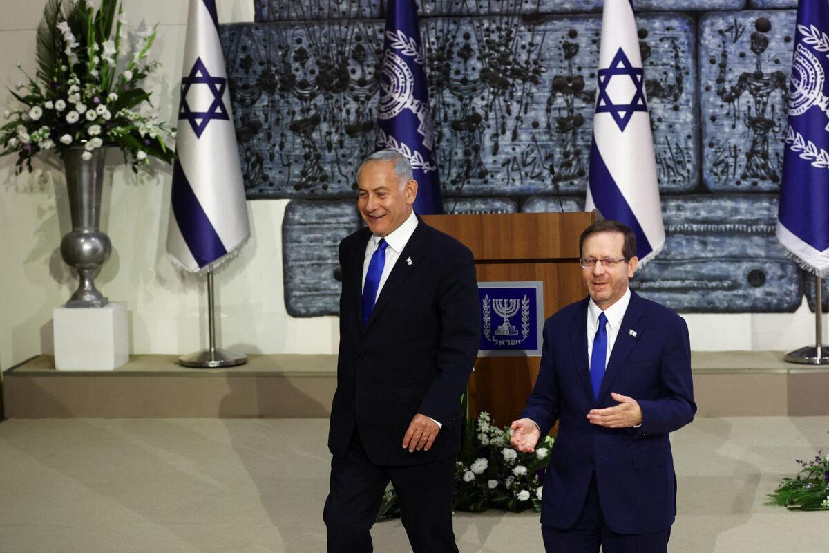 Israeli President Isaac Herzog (R) walks next to Prime Minister-elect Benjamin Netanyahu at the president's residency in Jerusalem on Nov. 13, 2022. (Ronen Zvulun/Reuters)