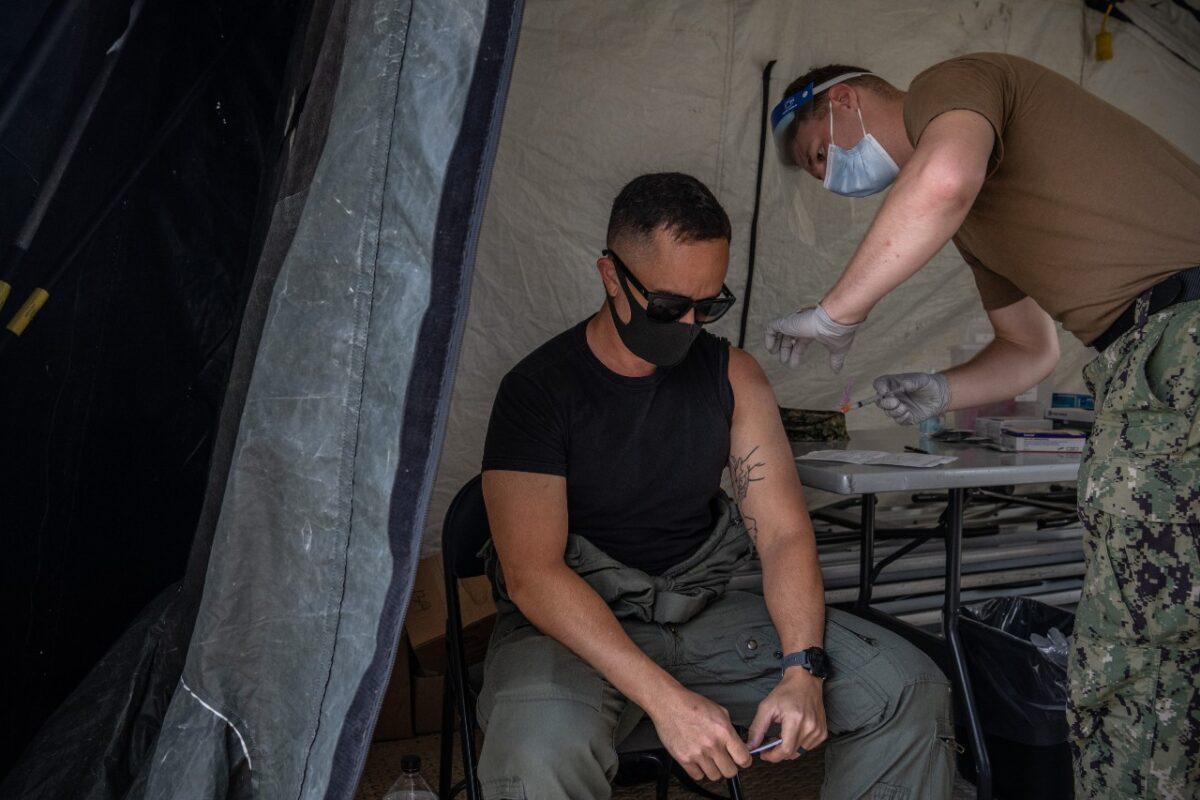 A member of the United States military receives the Moderna COVID-19 vaccine at Camp Foster in Ginowan, Japan, on April 28, 2021. (Carl Court/Getty Images)
