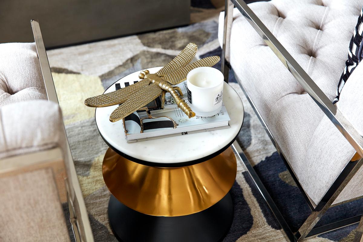 A black and gold accent table serves as a touch of glam and is paired with gold accents. (Scott Gabriel Morris/TNS)