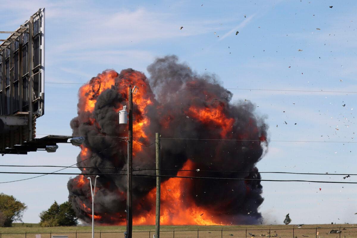 In this photo provided by Nathaniel Ross Photography, a historic military plane crashes after colliding with another plane during an airshow at Dallas Executive Airport in Dallas, Texas, on Nov. 12, 2022. (Nathaniel Ross Photography via AP)