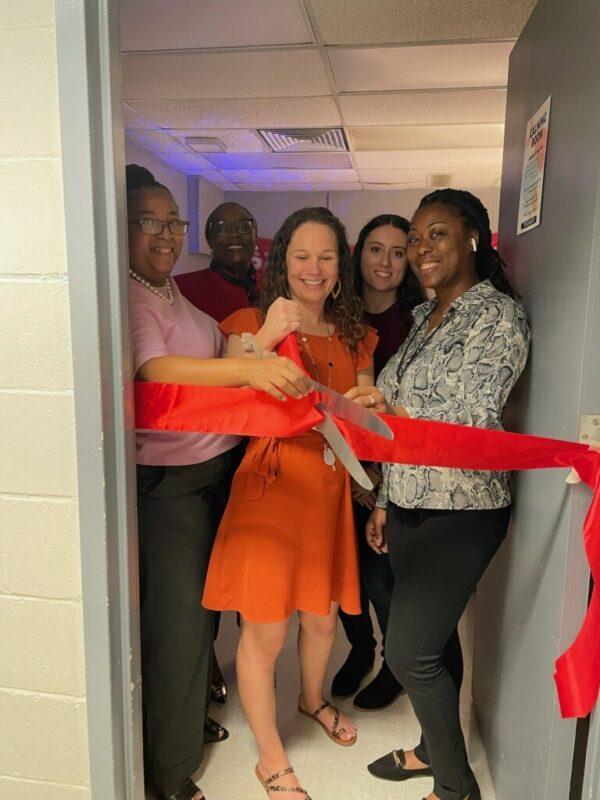 Members of the Alachua Sheriff's Office and administrators at Santa Fe High School cut a ribbon to celebrate the opening of a calming room in Alachua, Fla., on Nov. 1, 2022. (Courtesy of Alachua County Sheriff's Office)