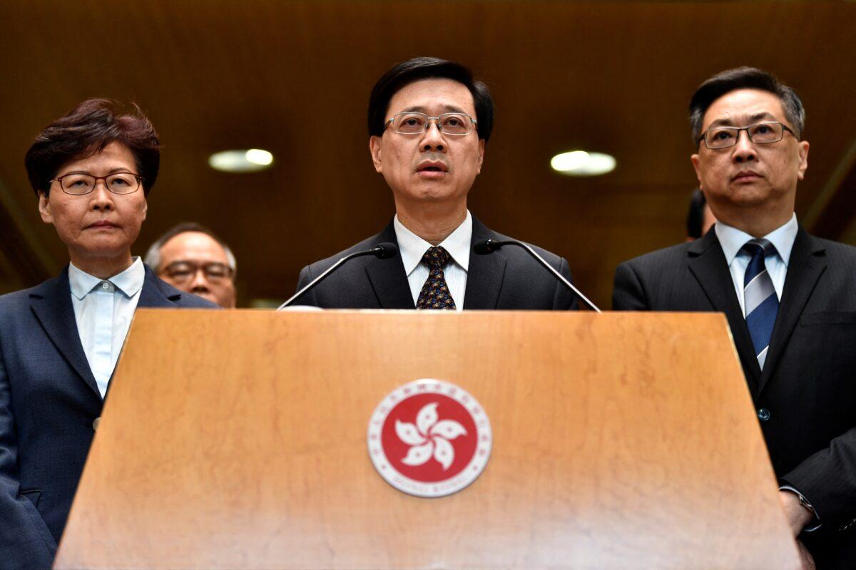 Hong Kong Chief Executive Carrie Lam (L) and police chief Stephen Lo (R) look on as Hong Kong's security chief, John Lee (C), addresses the media at a press conference in Hong Kong on July 22, 2019.(Anthony Wallace/AFP via Getty Images)