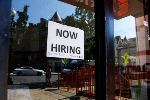 A "Now Hiring" sign is displayed on a storefront in Adams Morgan neighborhood in Washington, on Oct. 7, 2022. (Anna Moneymaker/Getty Images)