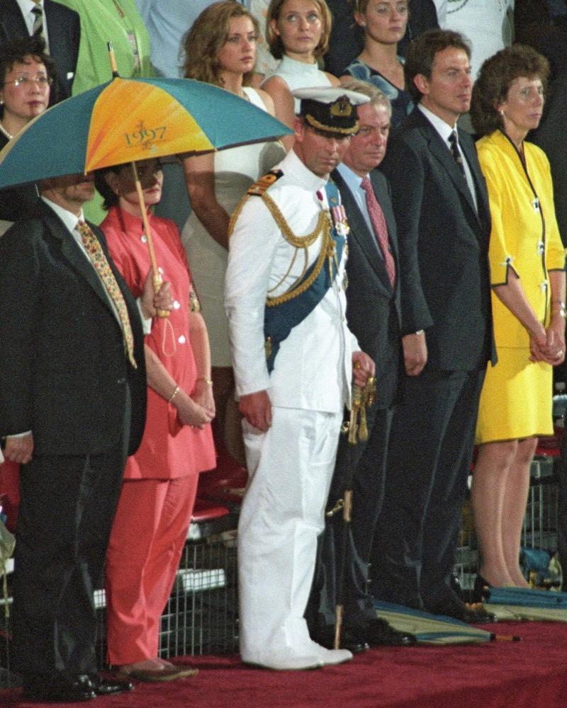 Britain's Prince Charles (C) watched the British Military Farewell Ceremony at the HMS Tamar military base in Hong Kong on June 30, 1997, marking the end of some 156 years of British colonial rule before the territory returned to Chinese control, along with British Foreign Secretary Robin Cook (L), British First Lady Cherie Blair (2nd L), the last Hong Kong Governor Chris Patten (3rd R), British Prime Minister Tony Blair (2nd R) and Patten's wife Lavendar (R). (AFP PHOTO/FILES/YOSHIKAZU TSUNO)