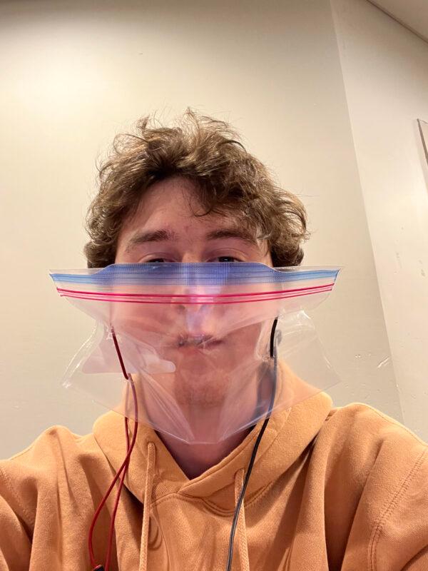 Kamil Bachouchi, a student at Wilfrid Laurier University, is protesting the school's mandatory masking policy in class by wearing a Ziploc bag with phone charging cables. (Courtesy of Kamil Bachouchi)