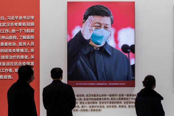 A picture of Chinese leader Xi Jinping wearing a mask is displayed at a convention center that was previously used as a makeshift hospital for patients in Wuhan, China, on Jan. 15, 2021. (Nicolas Asfouri/AFP via Getty Images)