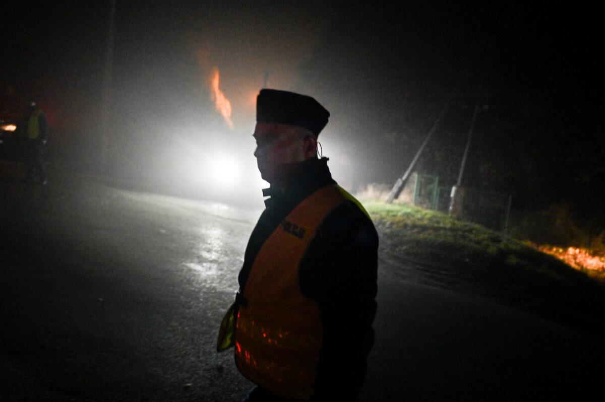 A police officer walks past a checkpoint following reports of a stray missile hitting Polish territory, killing two people in Przewodow, Poland, on Nov.16, 2022. (Omar Marques/Getty Images)