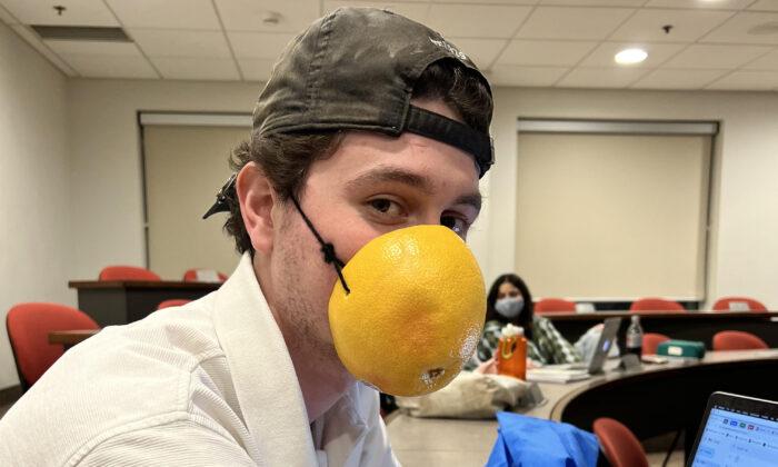 University Student Protests Mandate With Grapefruit ‘Mask’ One Day, Bucket on His Head Another