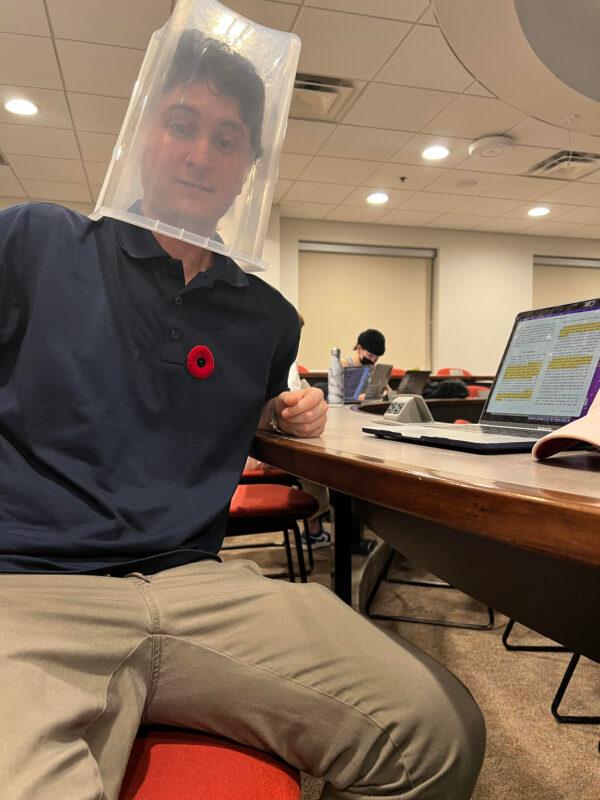 Kamil Bachouchi, a student at Wilfrid Laurier University, is protesting the school's mandatory masking policy in class by wearing a bucket. His nose and mouth are covered as required. (Courtesy of Kamil Bachouchi)